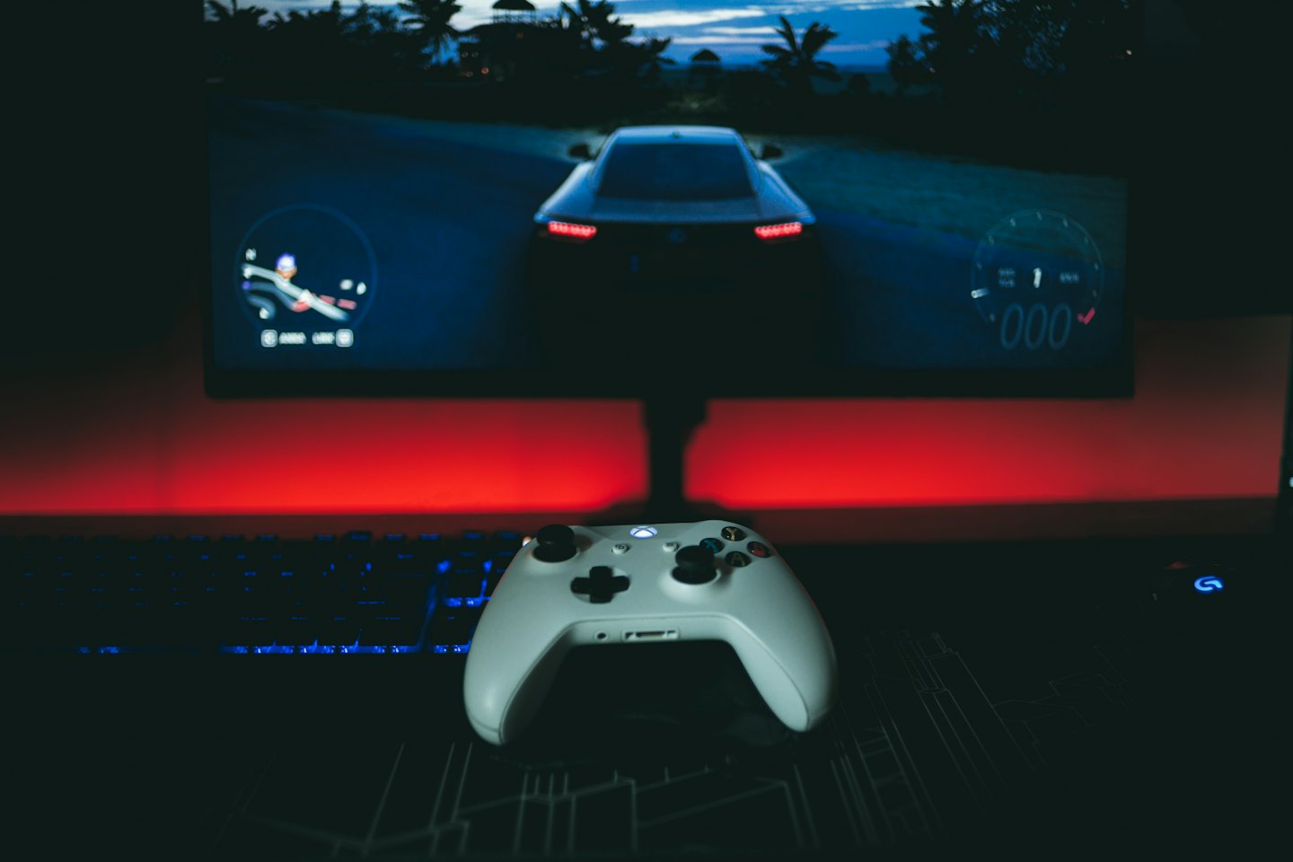White Xbox controller on a dark gaming desk.