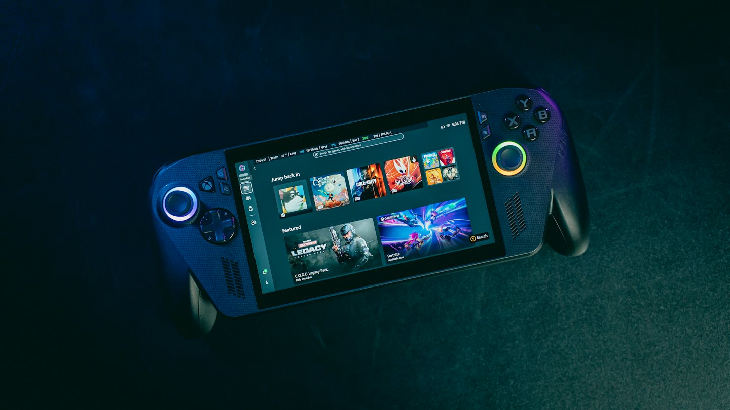 A handheld gaming console displaying game menus on its screen.