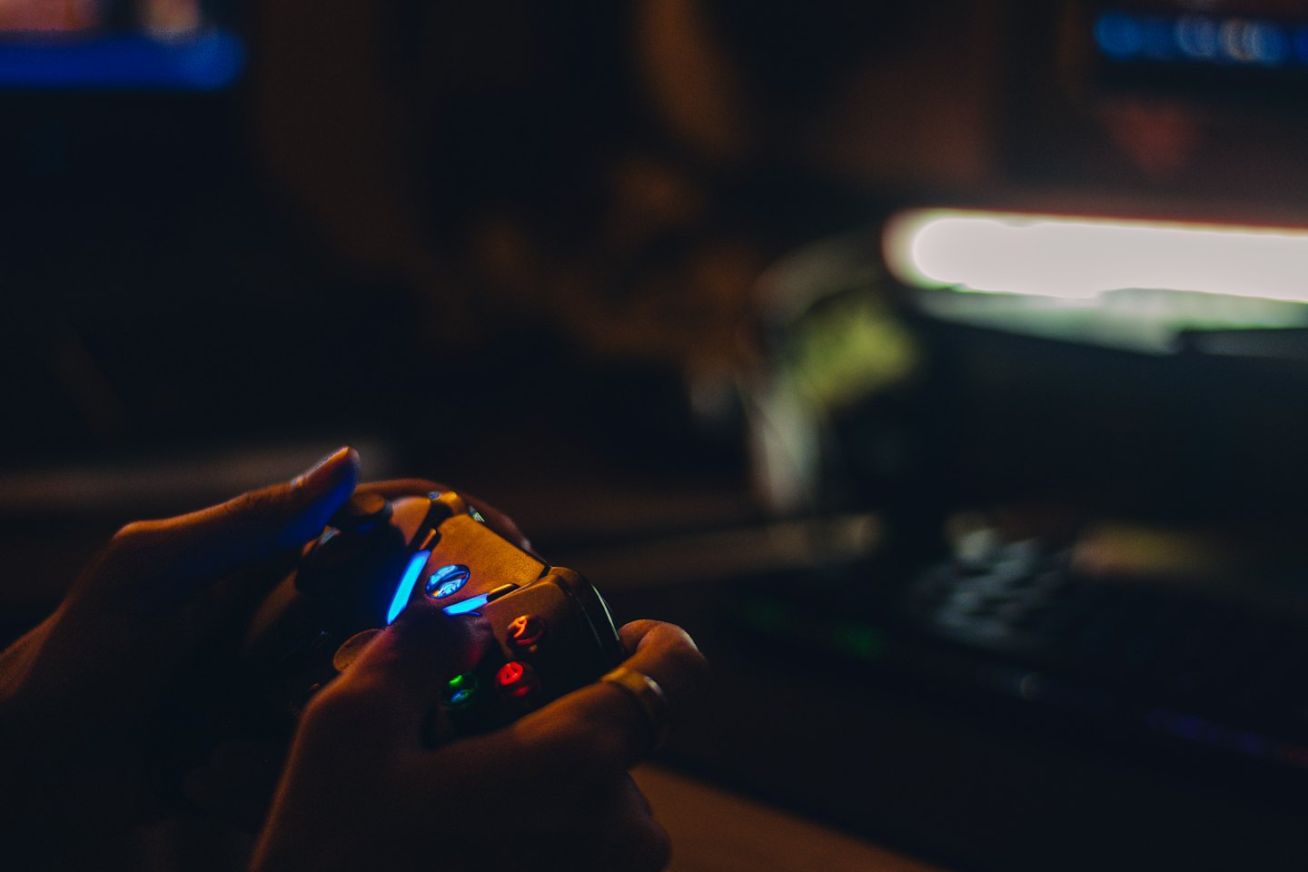 Two hands holding a colorful video game controller.