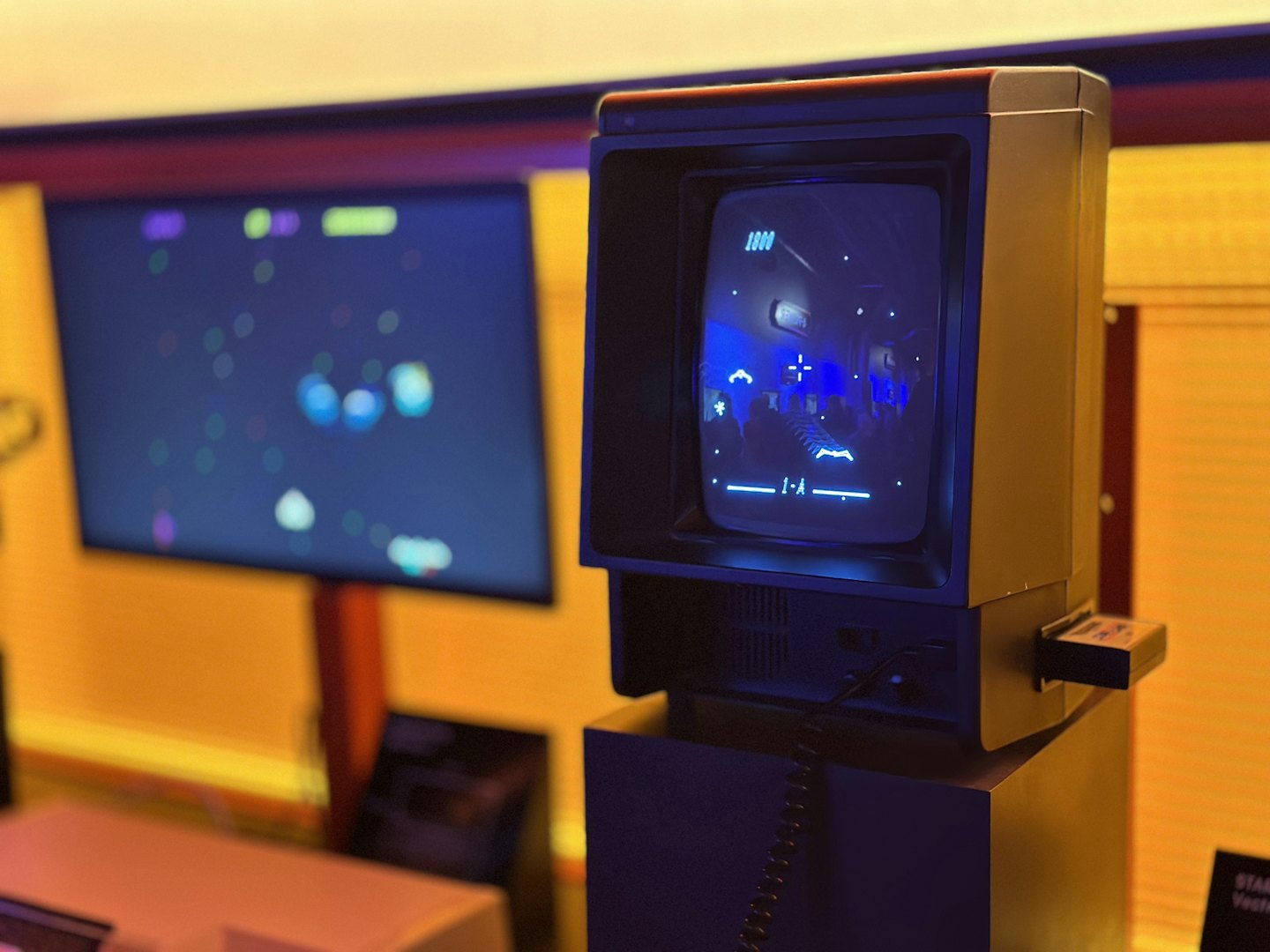 Vintage video game console screen displaying blue lines and graphics.
